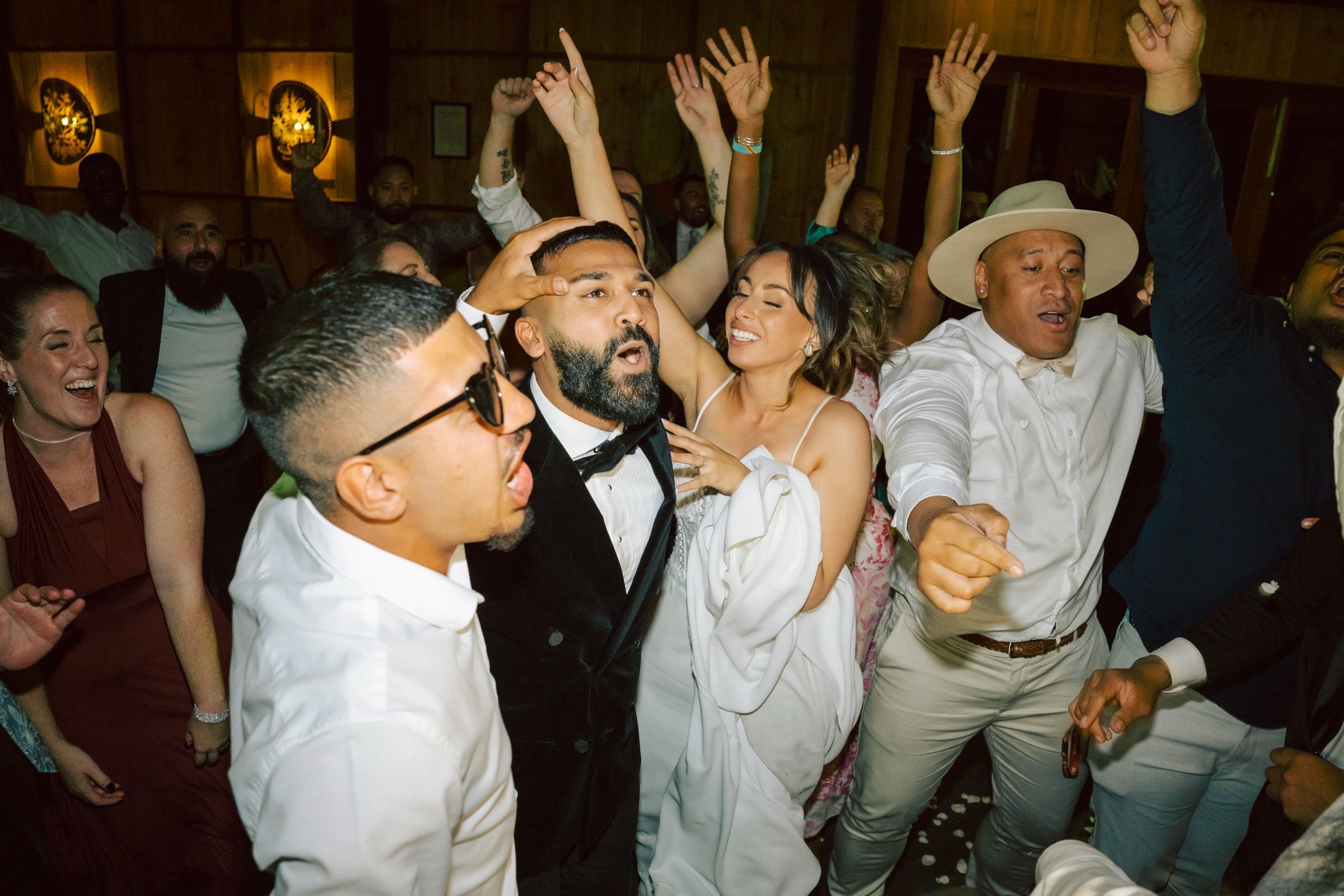 Wedding guests dancing around the bride and groom