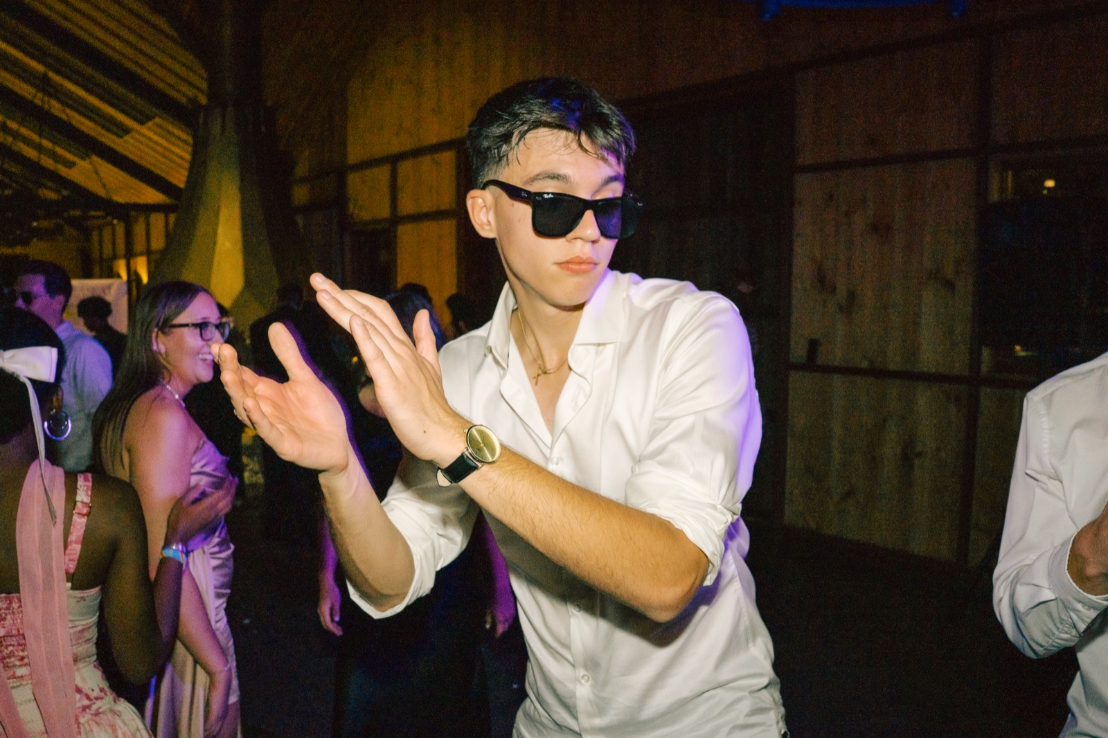 A guest in sunglasses dancing