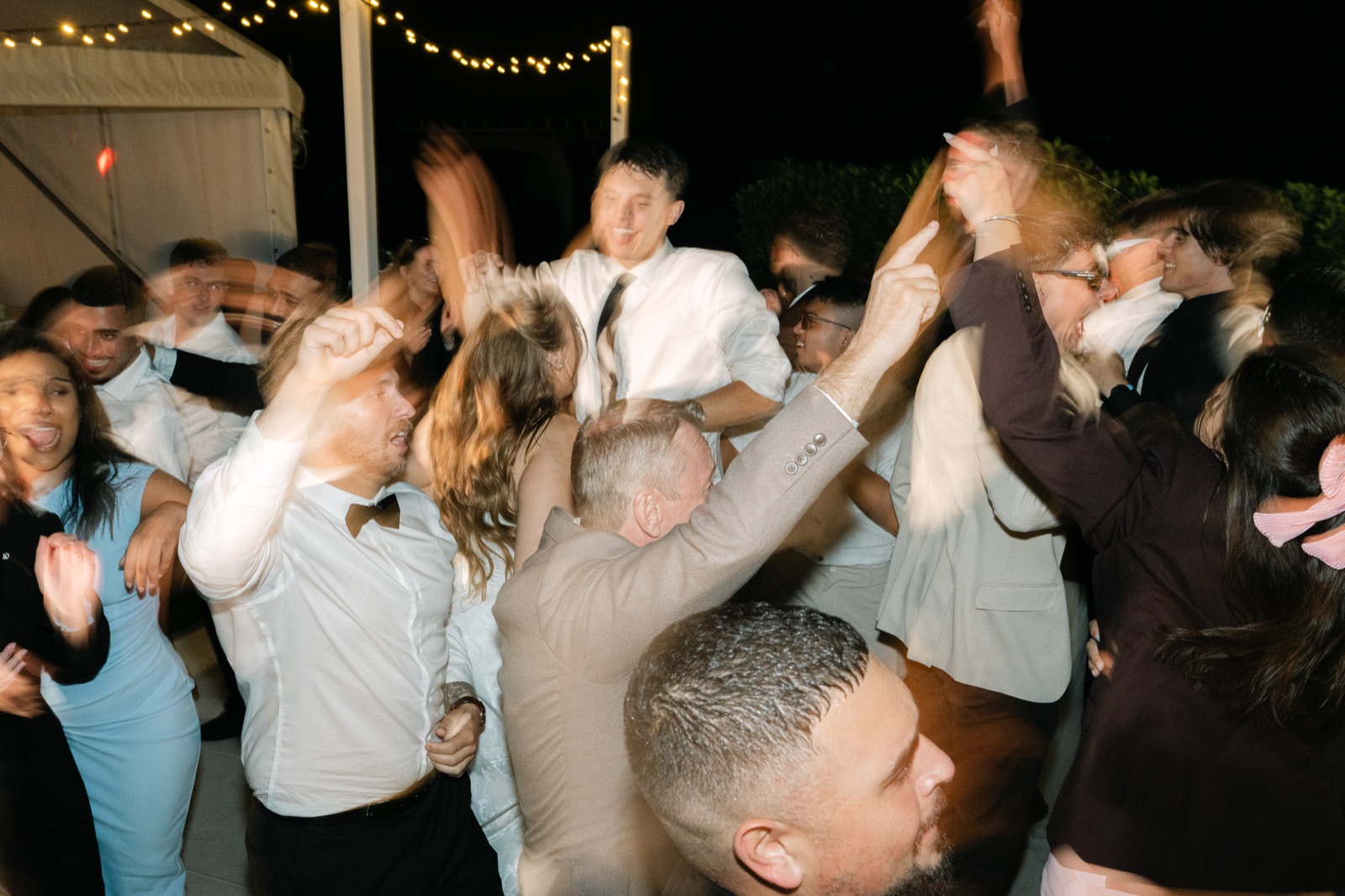 A crowd of guests dancing together